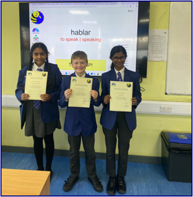 Three Year 7 students holding certificates
