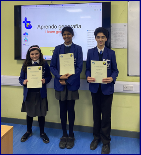 Three Year 7 Students holding Certificates at the front of the class